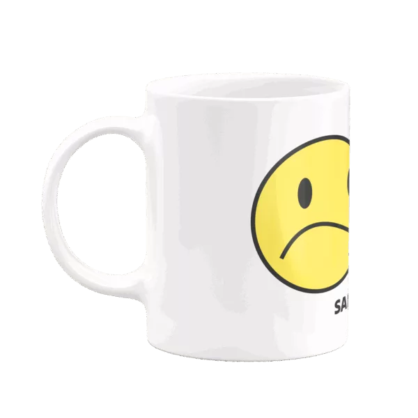 Mug "Sappy" avec un double smiley, un côté triste à gauche et un côté souriant à droite, visibles selon l’angle de vue.